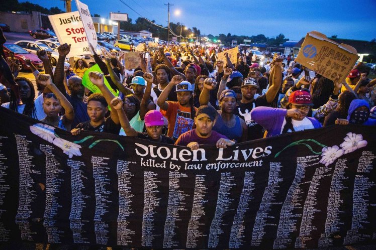 Protesters in Ferguson, Missouri, hold large banner containing the many names of individuals known to have been killed in confrontations with police. (Photo: Reuters)